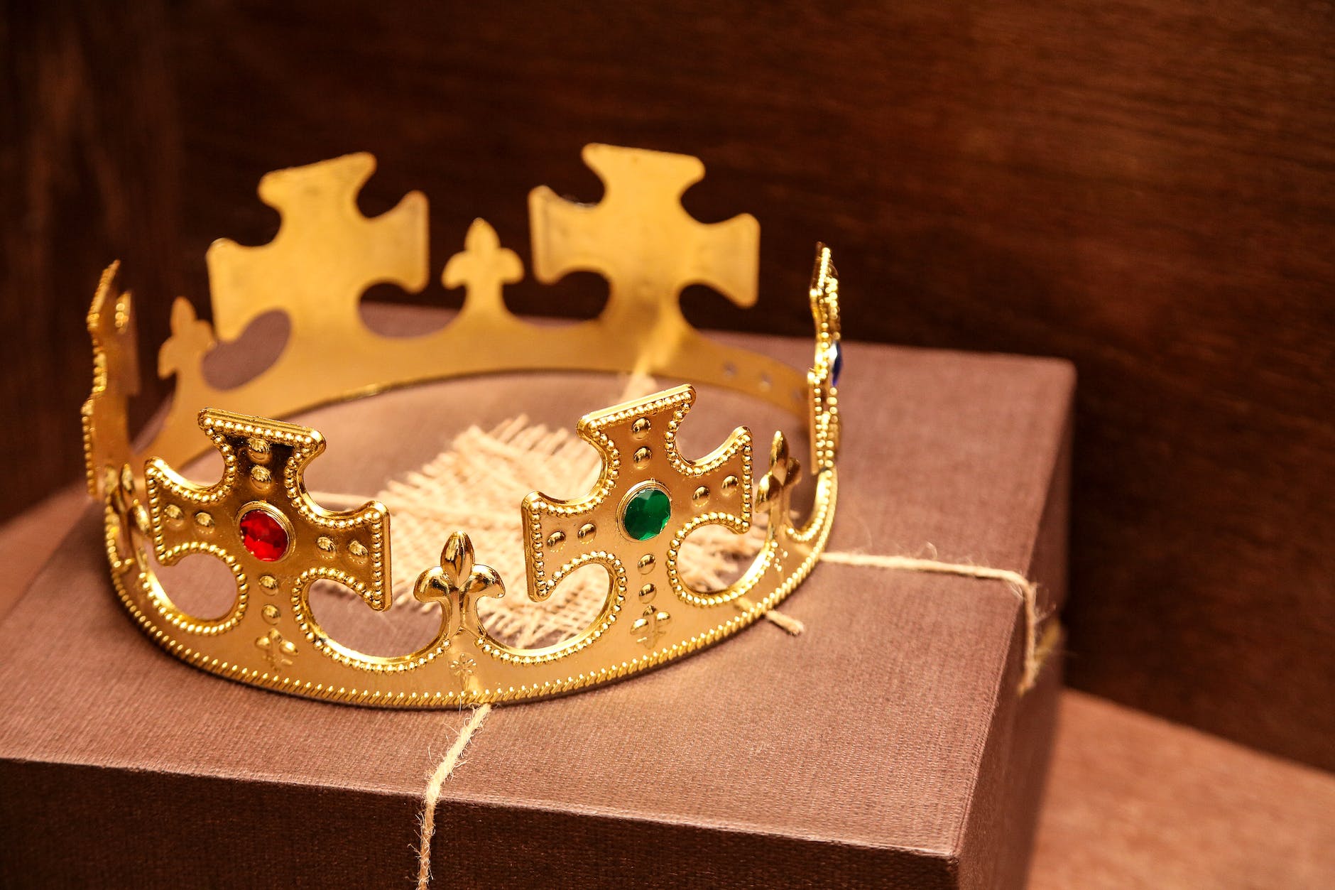 close up shot of king s crown on brown box