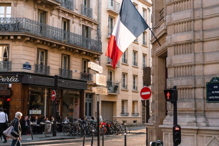 france flag on gray concrete building near road