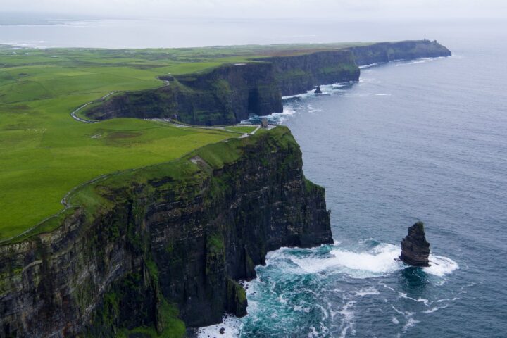 aerial photography of rock next to water body