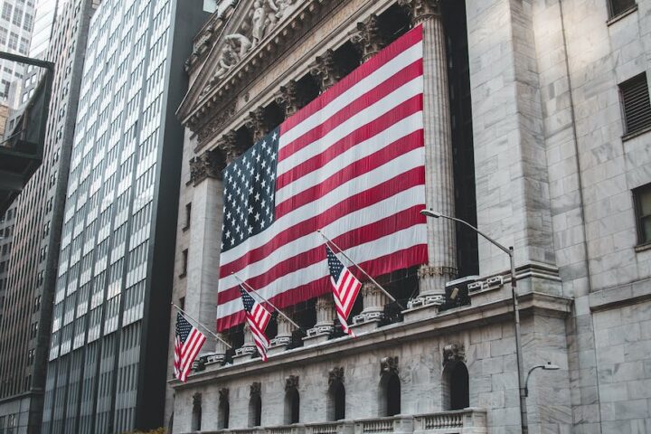 the american flag hanging outside the new york stock exchange