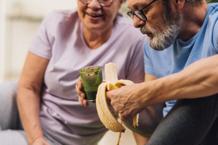 an elderly couple sitting on the floor while having conversation