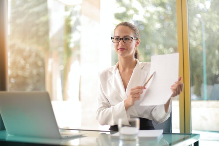 intelligent businesswoman explaining documents in office