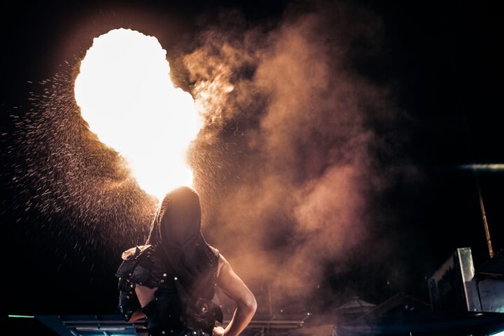 person standing beside fire during night time