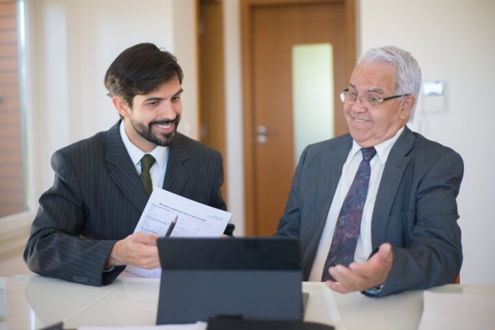 salesman discussing real estate to a senior man