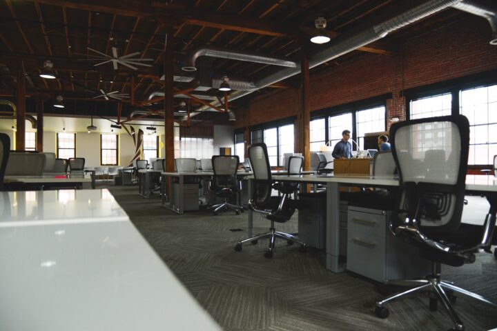 two men having conversation next to desk in building