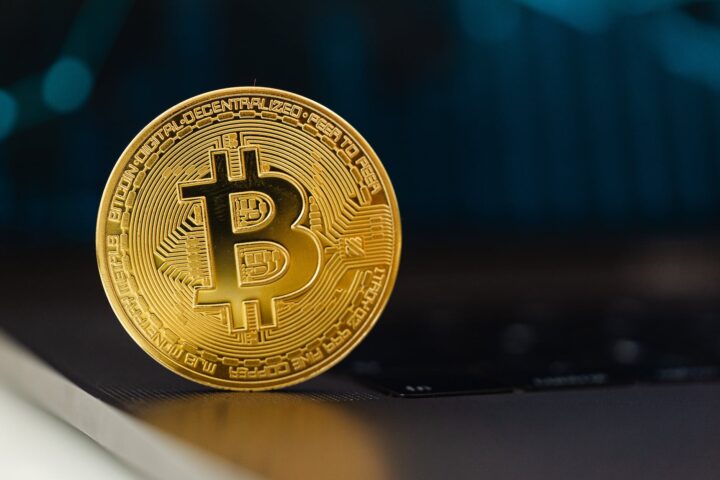 selective focus of a bitcoin on laptop computer