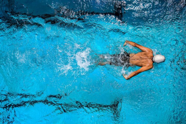 person swimming on body of water