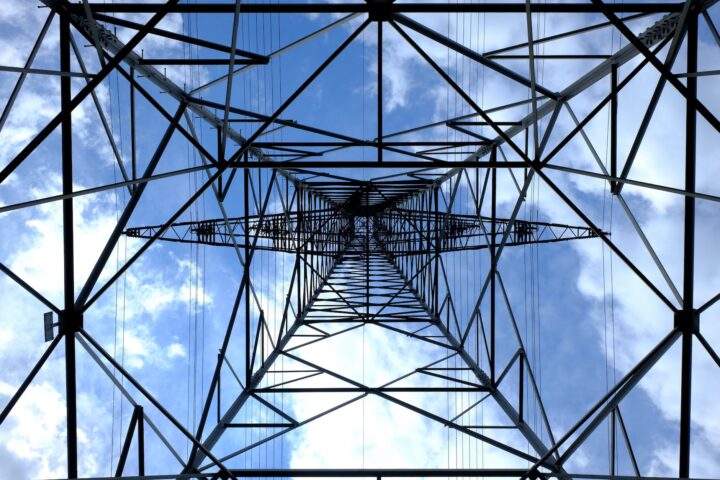 low angle photograph of black metal tower satellite during daytime