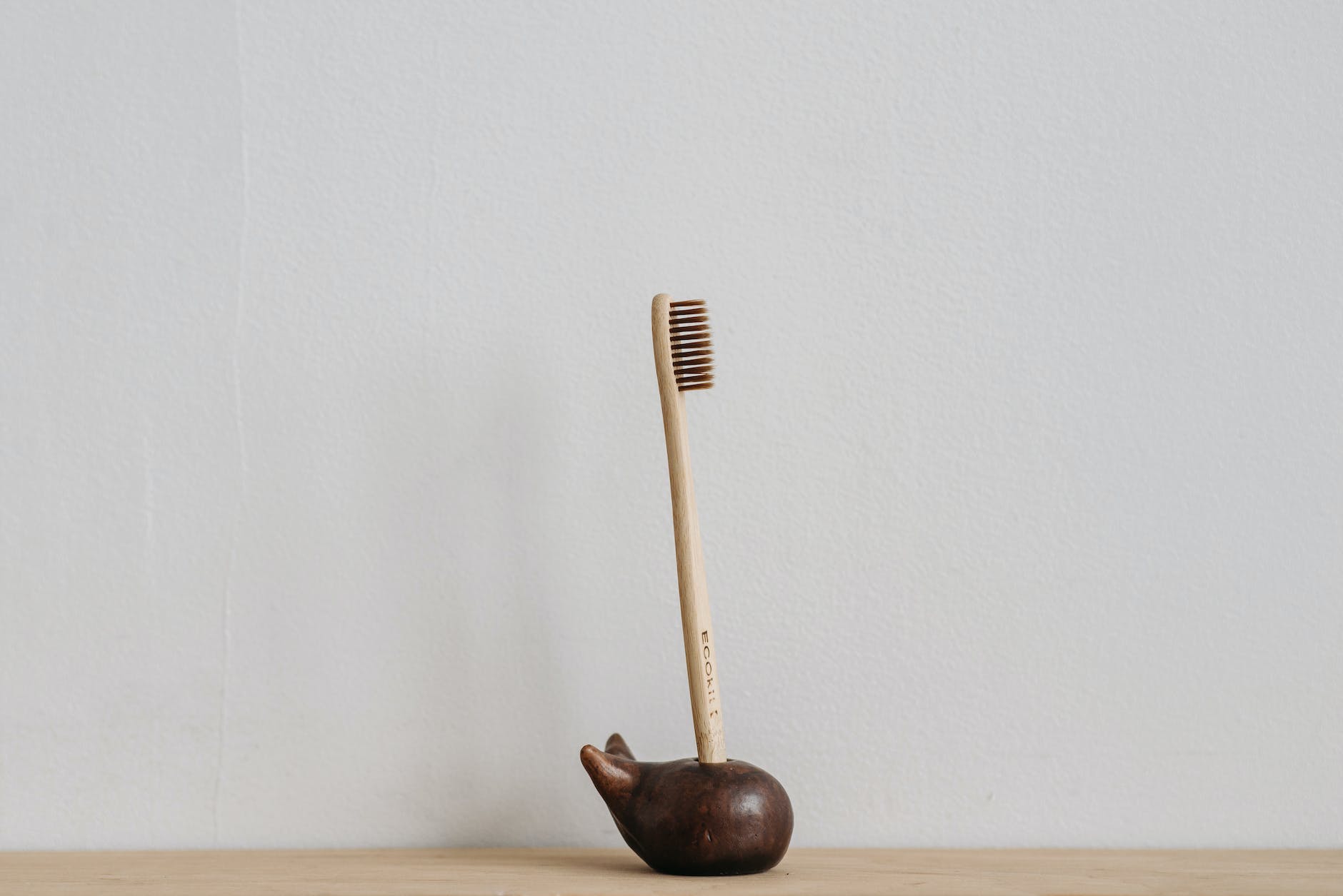 bamboo toothbrush in wooden toothbrush holder