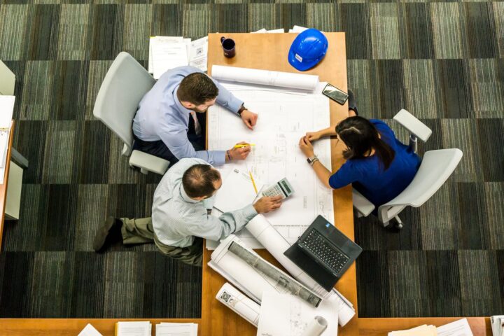 three people sitting beside table