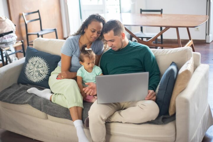 a family sitting on the sofa