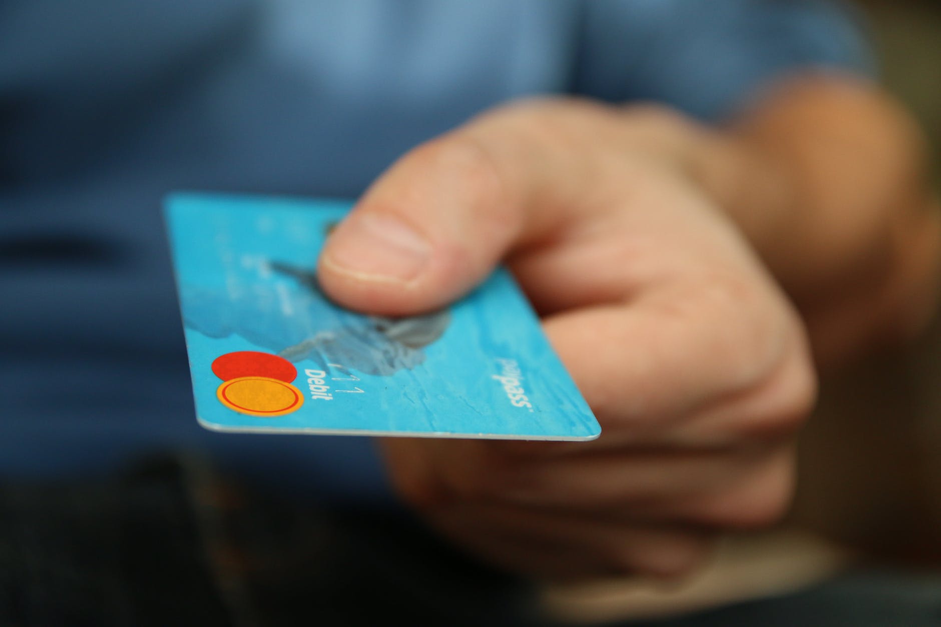 person holding debit card